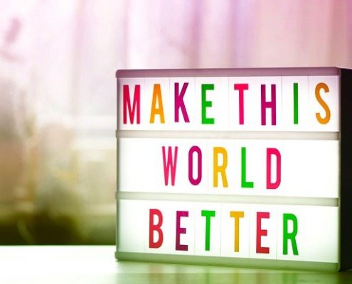 Coloured light box with the words 'Make this world better'